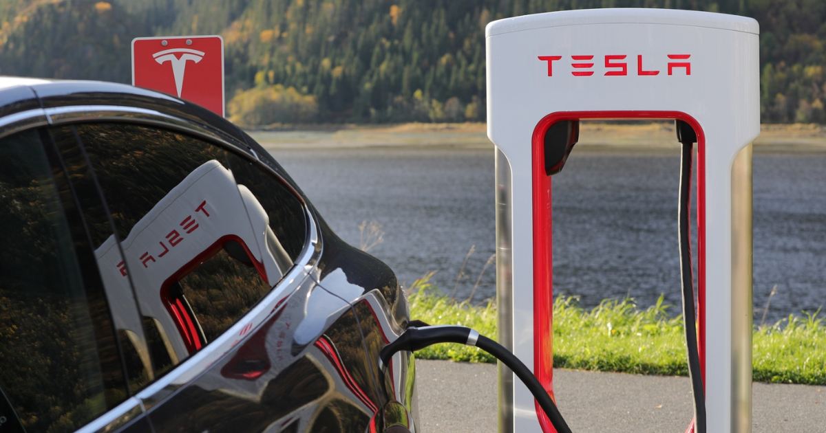 Tesla EV charging at charging station